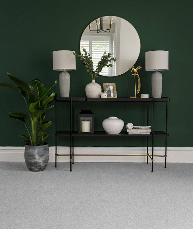 Dove grey Cormar carpet in living room against dark burgundy wall with cabinet